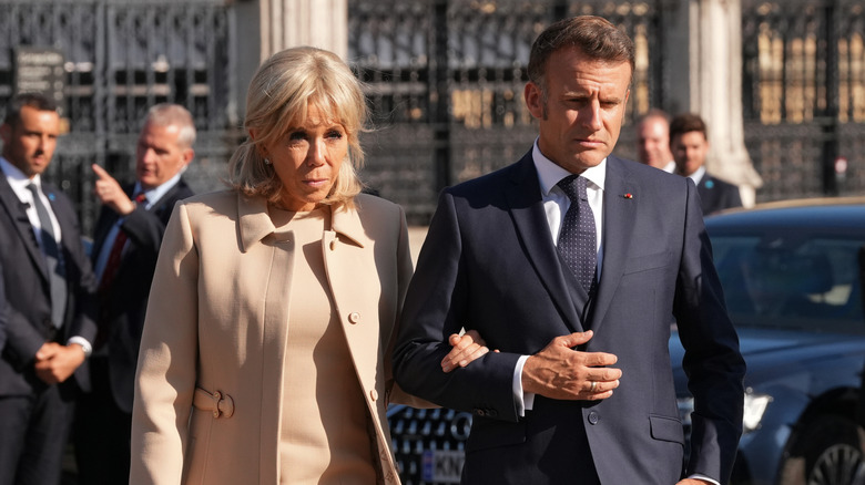 Emmanuel and Brigitte Macron walking