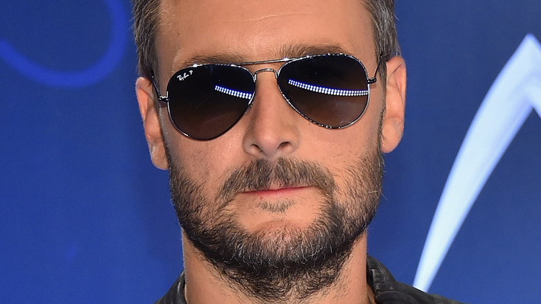 Eric Church posing with award for the Album of the Year 