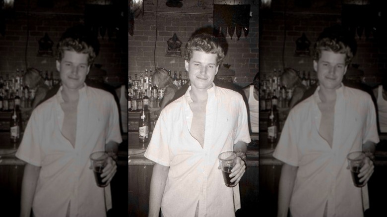 Young Eric Dane holds a glass