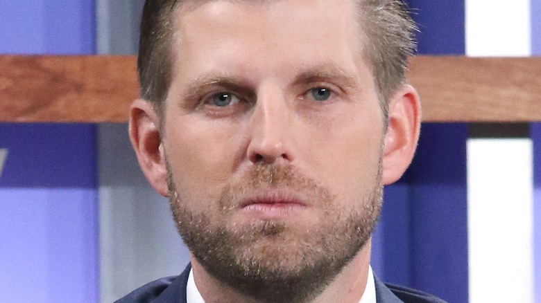 Eric Trump pursed lips blue eyes staring