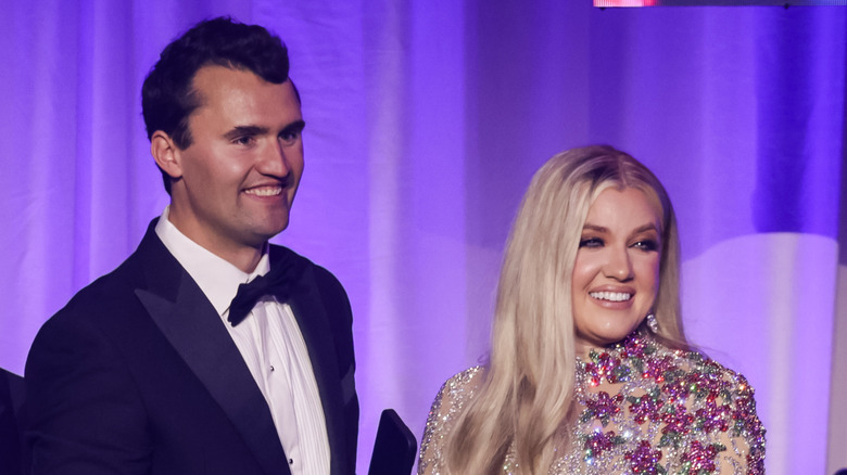 Charlie and Erika Kirk smiling onstage in their finery