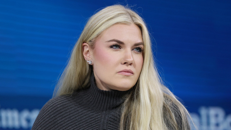 Erika Kirk glowering at at the audience in a grey turtleneck