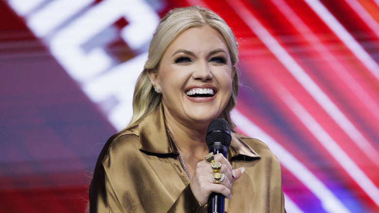 Erika Kirk holding a microphone