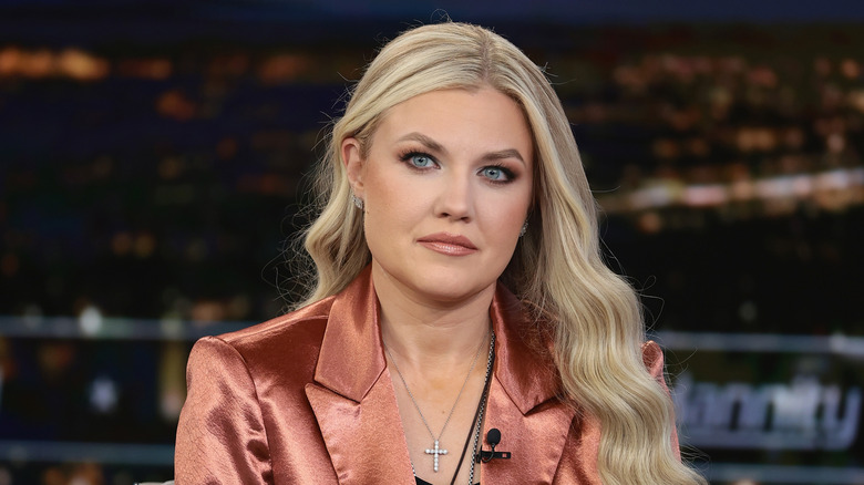 Erika Kirk wearing a burnt orange shiny blazer.