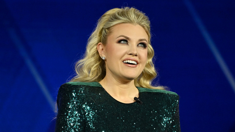 Erika Kirk with pageant makeup and green sequins