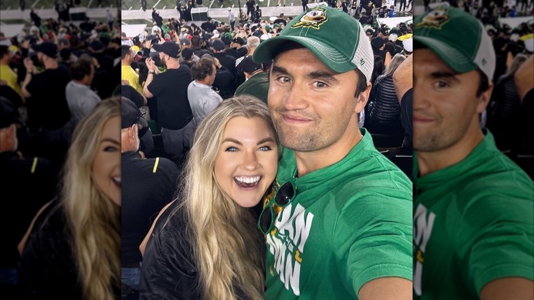 Charlie Kirk and Erika Kirk taking a selfie in the crowd at an Oregon Ducks game