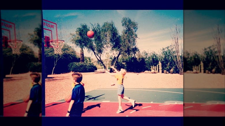 A young Erika Kirk throwing a basketball