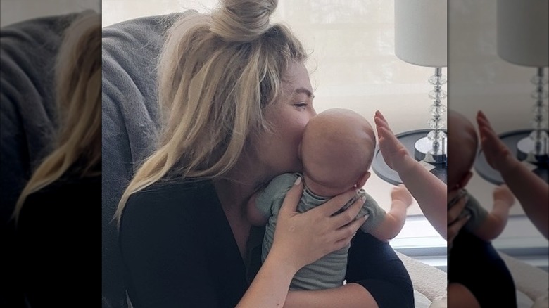 Erika Kirk kissing her newborn