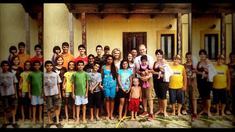 Erika Kirk posing with children from a Romanian orphanage