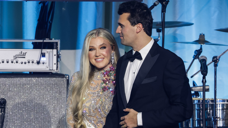 Erika Kirk wearing a beaded dress on stage with Charlie Kirk at the Turning Point USA Inaugural-Eve Ball