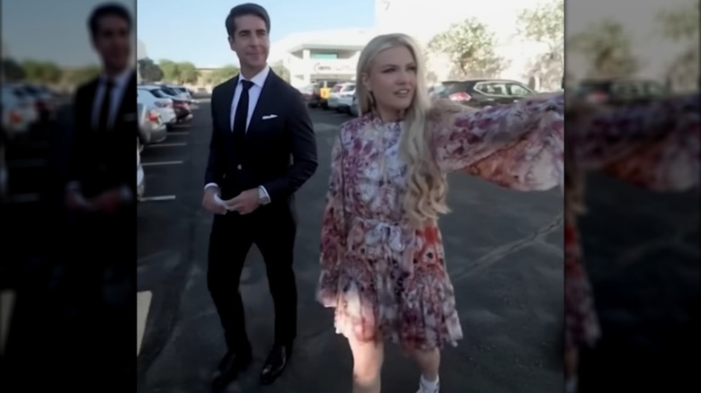Erika Kirk and Jesse Watters walking in a parking lot