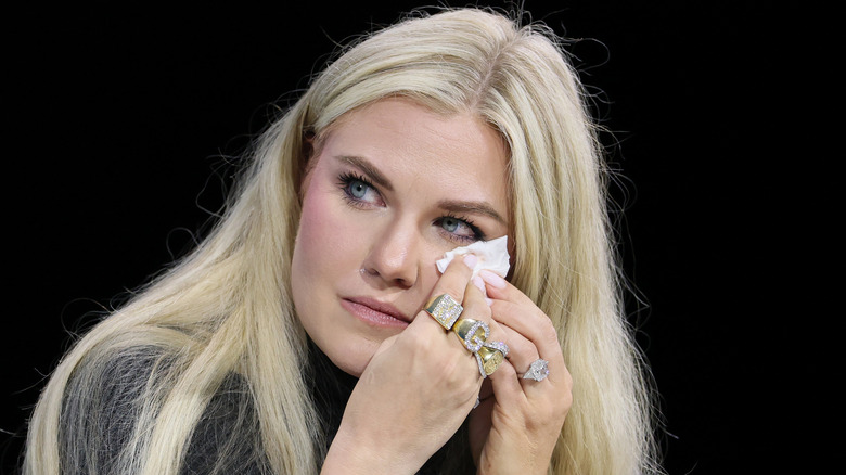 Erika Kirk crying and wiping her eyes during an interview.