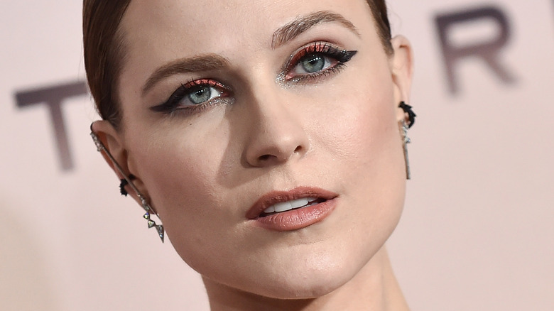 Evan Rachel Wood poses in red and black shimmery shadow