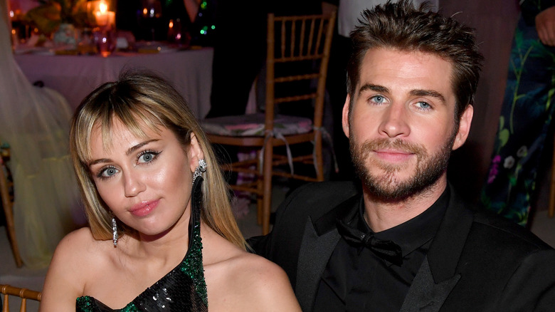 Miley Cyrus and Liam Hemsworth smiling