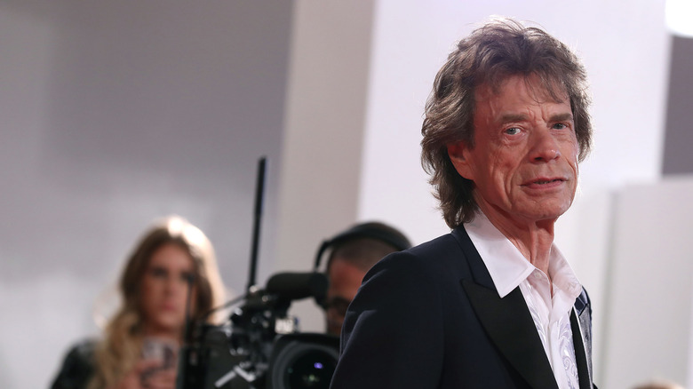 Mick Jagger turned to side, looking at camera