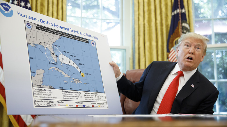 Donald Trump holding hurricane map