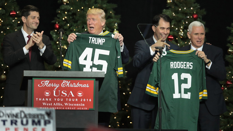 Donald Trump holding Packers jersey