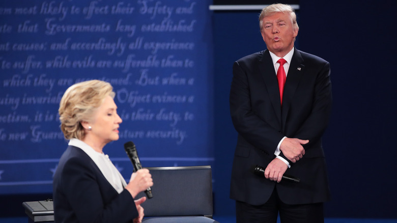 Hillary Clinton speaking, Donald Trump pursing lips
