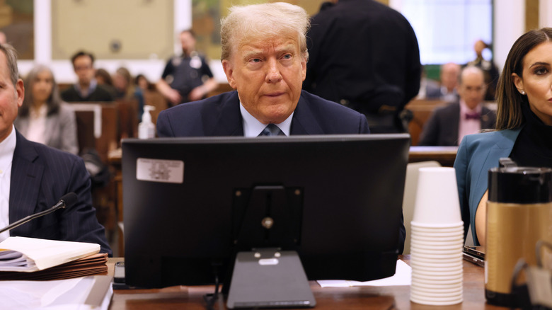 Donald Trump seated behind computer