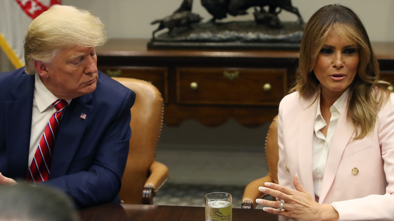 Donald and Melania Trump seated at table