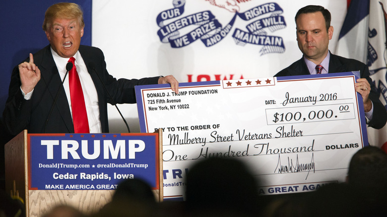 Donald Trump posing with giant check