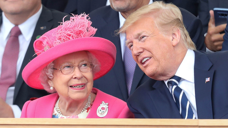Queen Elizabeth and Donald Trump, both smiling while seated