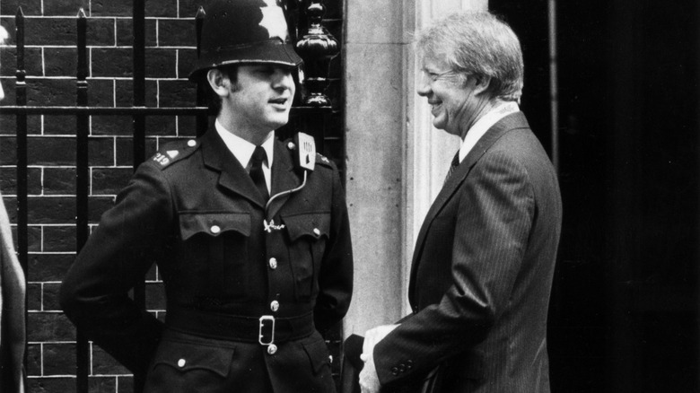Jimmy Carter and a British policeman, chatting