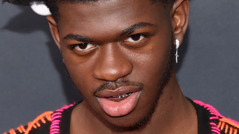 Lil Nas X wearing cross earring