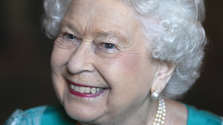 Queen Elizabeth II smiling with head cocked