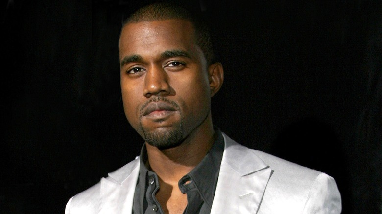 Kanye West posing in suit