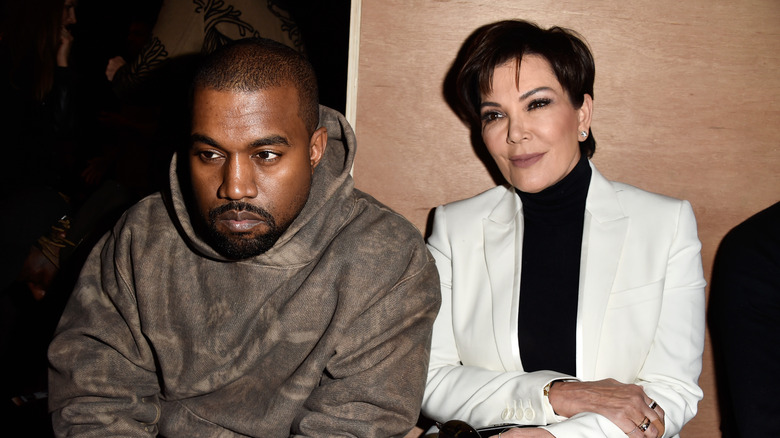 Kanye West looking glum beside Kris Jenner