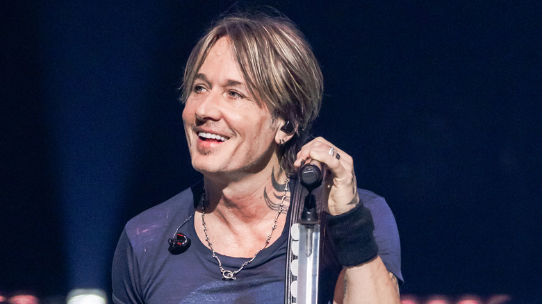 Keith Urban holding a microphone