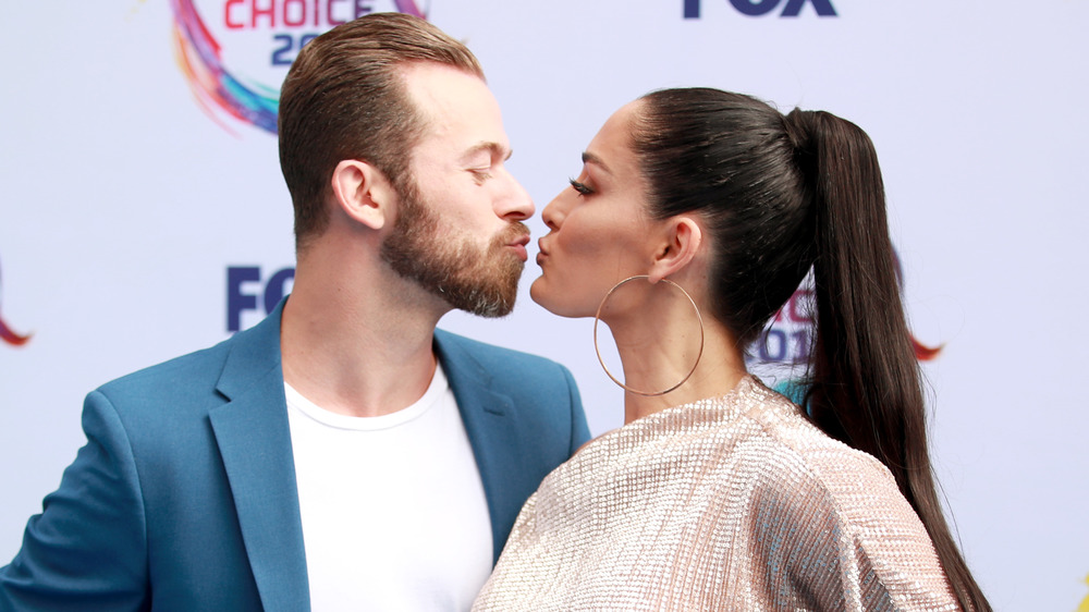 Artem Chigvintsev and Nikki Bella nearly kissing 