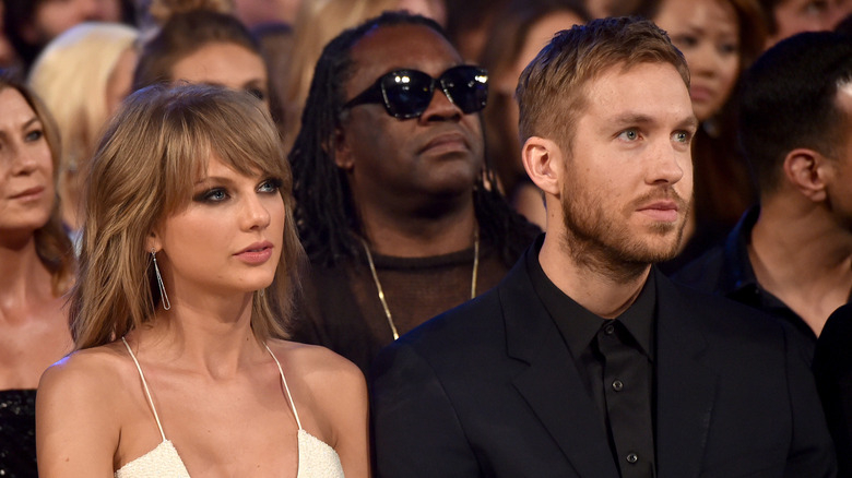 Taylor Swift and Calvin Harris sitting next to each other at an award show