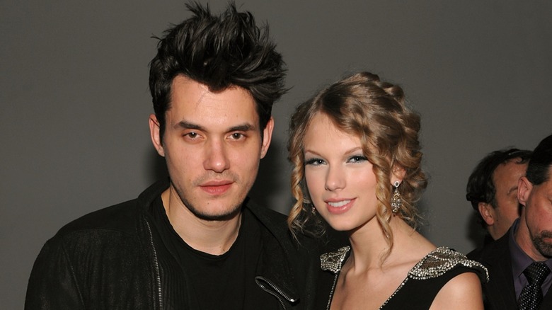 John Mayer and Taylor Swift posing for photos
