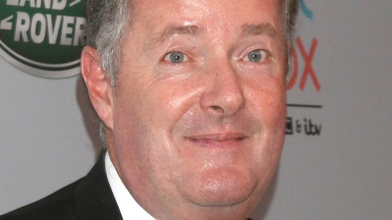 Piers Morgan double chin black jacket