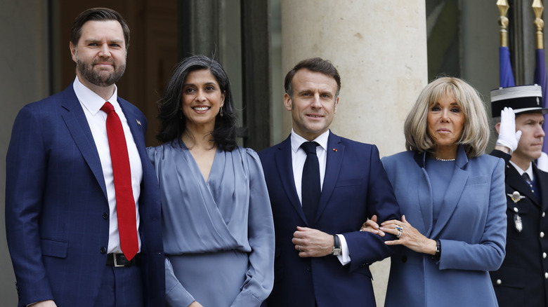 JD and Usha Vance smile for photographers in France