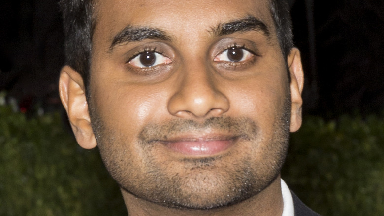 Aziz Ansari poses and wears a bowtie
