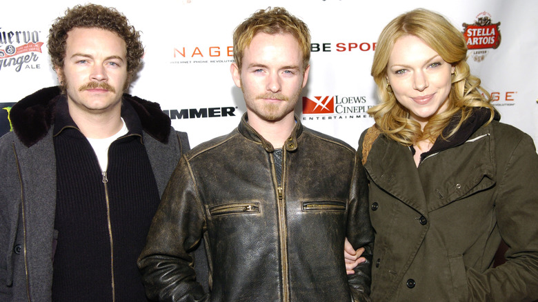 Danny Masterson, Christopher Masterson, Laura Prepon posing