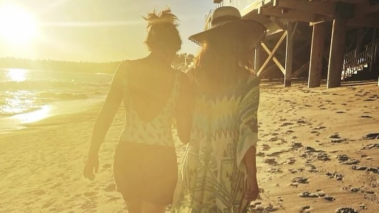 Halle and Nahla walking together on a beach.