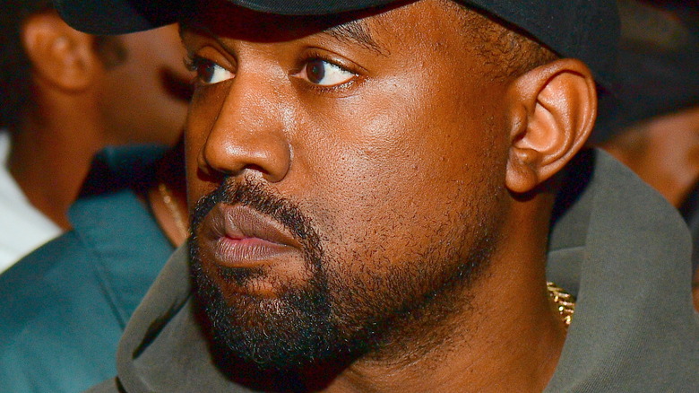 Kanye West wearing a cap