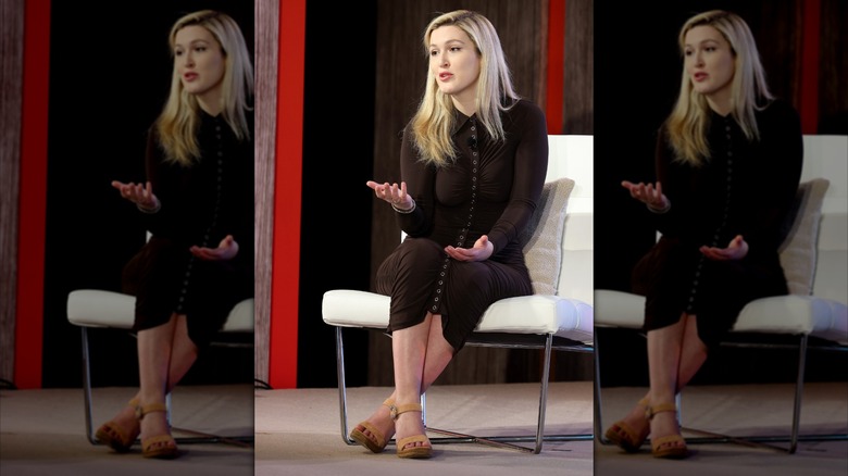 Reporter Olivia Nuzzi sitting on a chair speaking