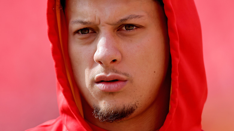 Patrick Mahomes wearing red hoodie at football practice 