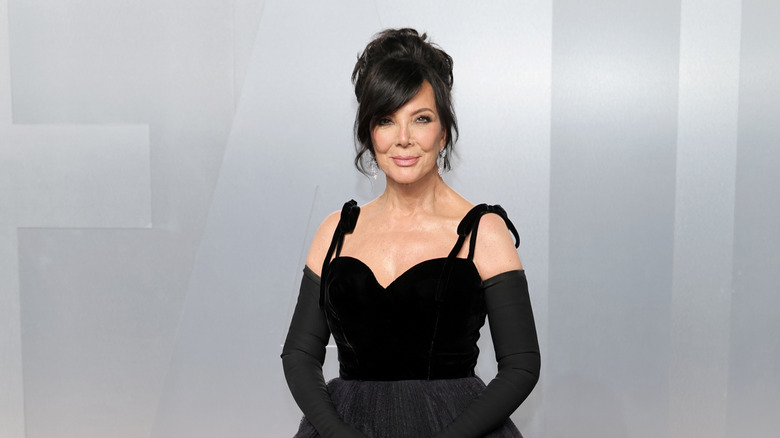 Kris Jenner posing in a black dress