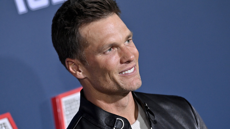 Kim Kardashian, pouting and Tom Brady, smiling