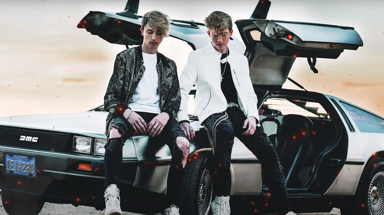 Cash and Maverick sitting on car