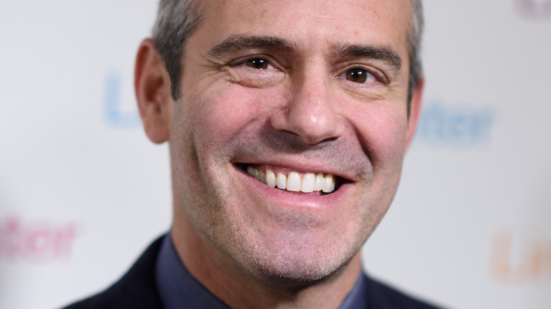 Andy Cohen smiling on red carpet