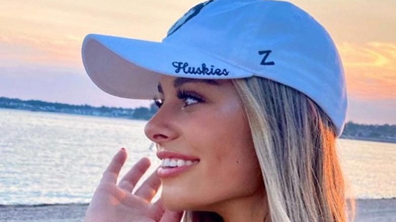 Annie Bonelli smiling and wearing baseball hat