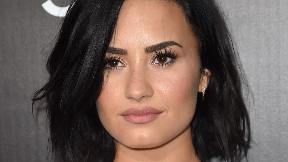 Demi Lovato with a neutral expression