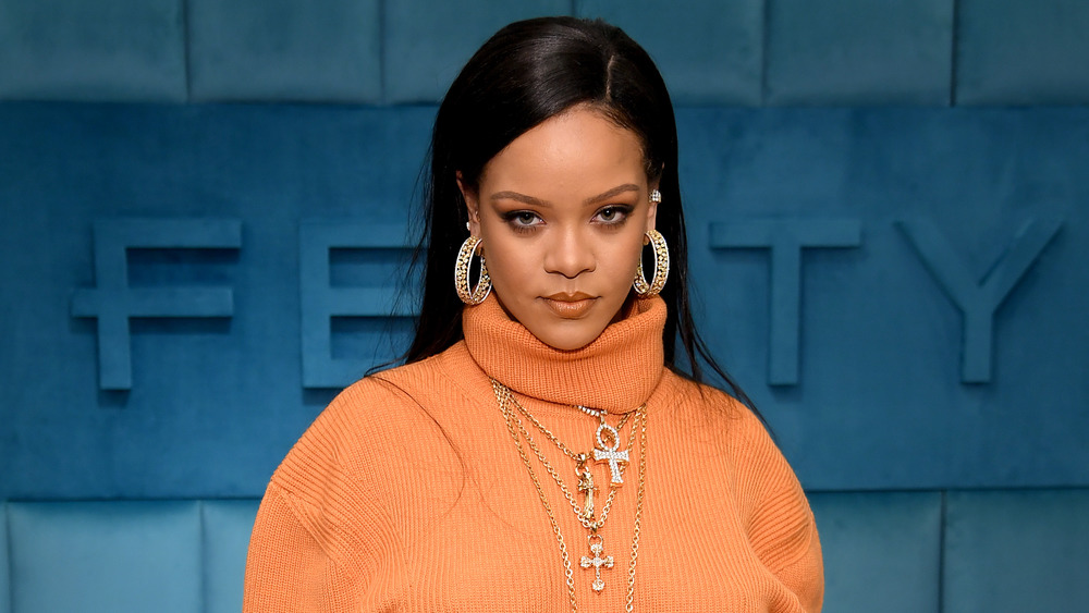 Rihanna orange sweater and jewelry